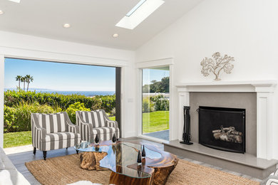 Transitional living room photo in Los Angeles with a standard fireplace and a stone fireplace