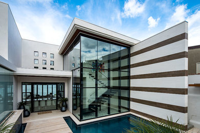 Example of a minimalist beige floor front door design in San Diego with white walls