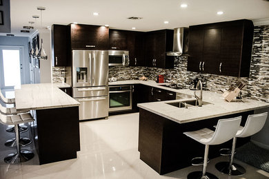 Open concept kitchen - mid-sized modern u-shaped ceramic tile open concept kitchen idea in Miami with a double-bowl sink, flat-panel cabinets, dark wood cabinets, marble countertops, multicolored backsplash, matchstick tile backsplash and stainless steel appliances