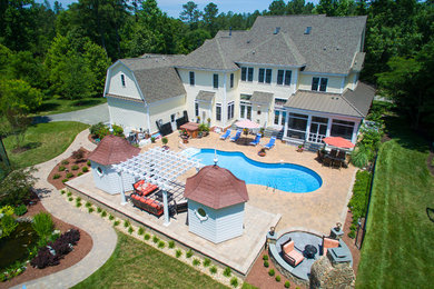Inspiration for a huge traditional full sun backyard brick landscaping in Richmond with a fire pit.