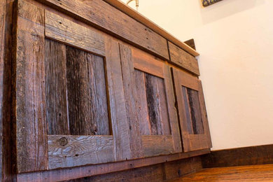 Inspiration for a rustic single-wall kitchen remodel in Other with flat-panel cabinets, dark wood cabinets and laminate countertops