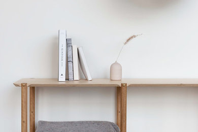 This is an example of a small scandinavian open plan dining in Melbourne with white walls, painted wood floors, no fireplace and white floor.