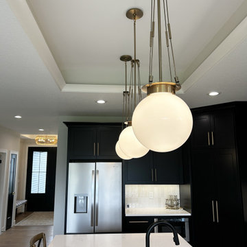 Black and Maple Wheat Kitchen with Brass Banded Hood