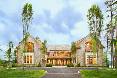 Design ideas for an expansive traditional two-storey exterior in Other with stone veneer.