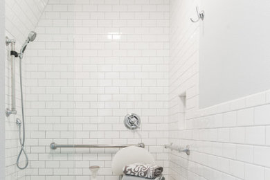 Inspiration for a mid-sized transitional white tile and ceramic tile ceramic tile, gray floor and single-sink bathroom remodel in Dallas with raised-panel cabinets, white cabinets, a two-piece toilet, gray walls, an integrated sink, solid surface countertops and white countertops