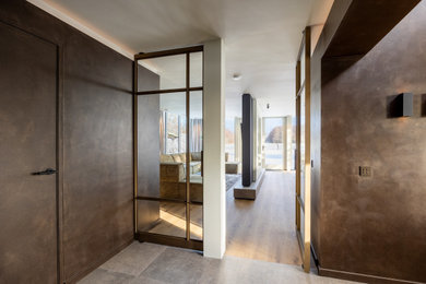 Inspiration for a large contemporary open plan living room in London with brown walls.