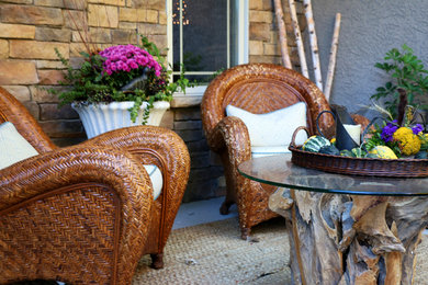 This is an example of a mid-sized transitional concrete front porch design in Kansas City.