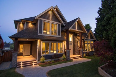 Design ideas for a mid-sized traditional two-storey grey exterior in Vancouver with mixed siding and a gable roof.