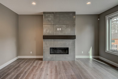 Living room - mid-sized transitional formal and open concept medium tone wood floor living room idea in Edmonton with beige walls, a ribbon fireplace, a concrete fireplace and a wall-mounted tv