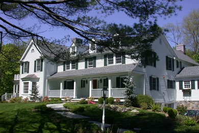 Large elegant white three-story wood gable roof photo in New York