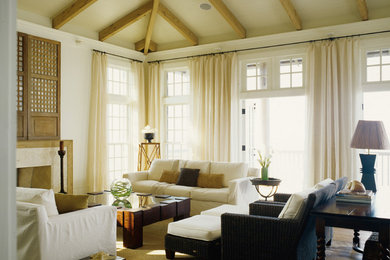 Example of a mid-sized island style formal and enclosed dark wood floor living room design in Miami with white walls, a standard fireplace and a tile fireplace
