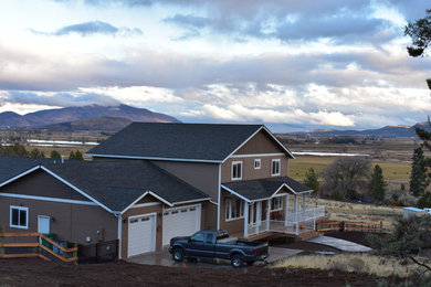 Example of a mid-sized transitional brown two-story vinyl exterior home design in Other with a shingle roof