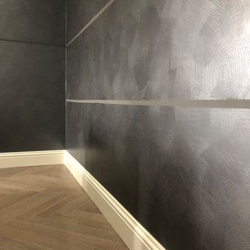 Stripe bespoke walls in dark tones and silver finish with modern furniture