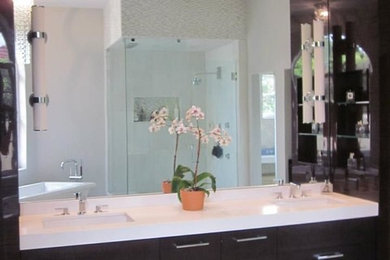 Large trendy master multicolored tile and marble tile marble floor and white floor freestanding bathtub photo in Orlando with flat-panel cabinets, brown cabinets, gray walls, quartz countertops and white countertops