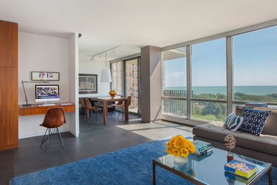 Example of a mid-sized trendy formal and open concept porcelain tile living room design in Chicago with white walls, no fireplace and a wall-mounted tv