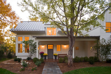 Example of a mid-sized farmhouse white two-story wood exterior home design in Denver with a metal roof and a white roof