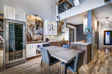Kitchen - mid-sized transitional galley medium tone wood floor kitchen idea in Montreal with recessed-panel cabinets, white cabinets, quartz countertops, stainless steel appliances, white backsplash and no island