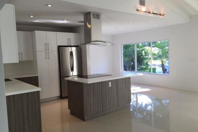 Eat-in kitchen - large transitional l-shaped linoleum floor eat-in kitchen idea in Miami with flat-panel cabinets, white cabinets, stainless steel appliances and an island