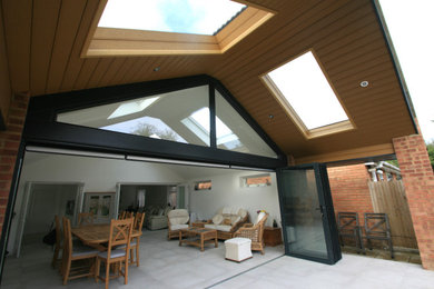 Design ideas for a contemporary ground level terrace in Other with a roof extension.