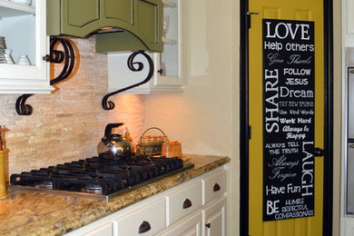 Inspiration for a mid-sized transitional single-wall slate floor eat-in kitchen remodel in Houston with a farmhouse sink, raised-panel cabinets, white cabinets, granite countertops, beige backsplash, stone tile backsplash, stainless steel appliances and an island
