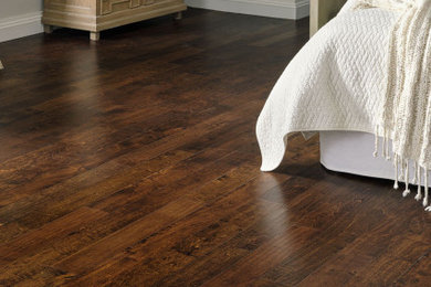 Elegant dark wood floor and brown floor bedroom photo in Raleigh