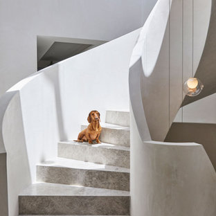 Photo of an expansive modern limestone spiral staircase in Melbourne with limestone risers.