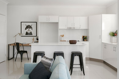 Inspiration for a modern l-shaped eat-in kitchen in Brisbane with a double-bowl sink, white cabinets, quartz benchtops, white splashback, ceramic splashback, stainless steel appliances and porcelain floors.