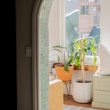 Arched Built-Ins Meet Terracotta Tile in a Light-Filled Sunroom Addition