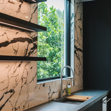 Culinary Chic: Chef's Kitchen with Slab Backsplash and Integrated Lighting