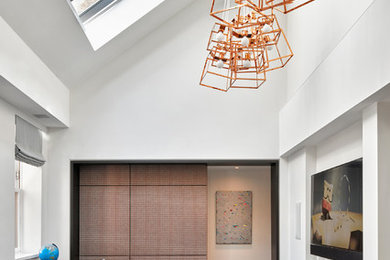 Kids' room - contemporary gender-neutral dark wood floor kids' room idea in New York with white walls