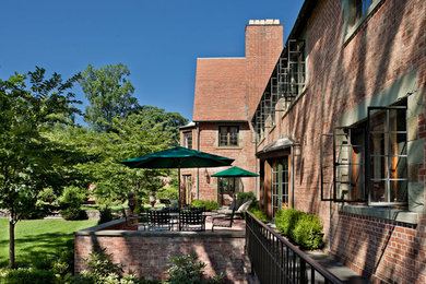 Inspiration for a timeless brown three-story brick house exterior remodel in Bridgeport with a shed roof and a shingle roof