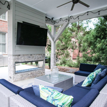 Luxury Outdoor Lounge with Fireplace, TV, and Outdoor String Lights