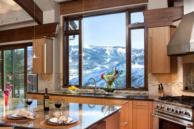 Mid-sized trendy l-shaped medium tone wood floor eat-in kitchen photo in Denver with stainless steel appliances, an undermount sink, flat-panel cabinets, medium tone wood cabinets, granite countertops, beige backsplash, ceramic backsplash, an island and brown countertops