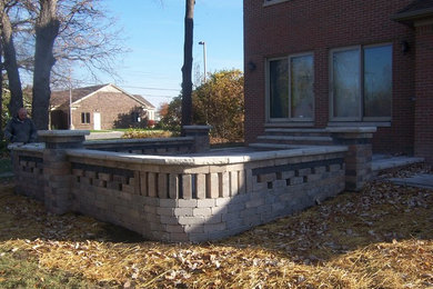 Inspiration for a contemporary partial sun courtyard brick landscaping in Detroit.