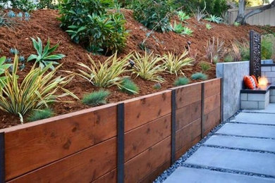 This is an example of a country backyard garden in Melbourne with a retaining wall.