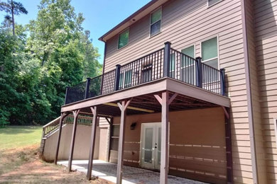 Inspiration for a large contemporary backyard second story privacy and metal railing deck remodel in Other