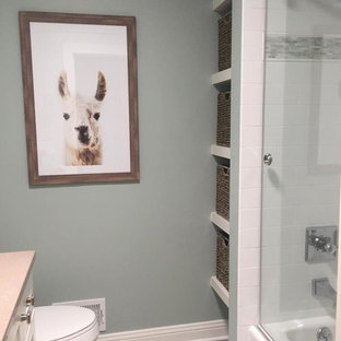Inspiration for a transitional 3/4 white tile and ceramic tile ceramic floor and turquoise floor bathroom remodel in Milwaukee with shaker cabinets, white cabinets, a two-piece toilet, blue walls, an undermount sink, quartz countertops and gray countertops