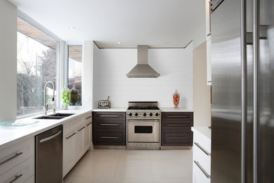 Example of a beach style kitchen design with mosaic tile backsplash
