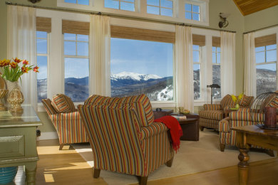 Inspiration for a large rustic enclosed medium tone wood floor and brown floor family room remodel in Boston