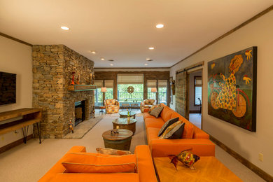 Inspiration for a mid-sized rustic open concept and formal carpeted and beige floor living room remodel in Other with gray walls, a standard fireplace, a stone fireplace and a wall-mounted tv