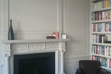 Large trendy dark wood floor living room photo in London with gray walls and a wood fireplace surround