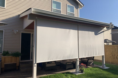 Example of a mid-sized cottage backyard concrete patio kitchen design in Seattle with an awning