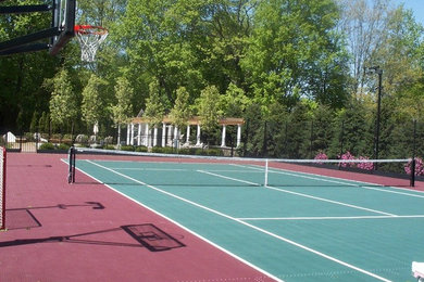 Photo of a large traditional partial sun backyard concrete paver outdoor sport court in Boston.