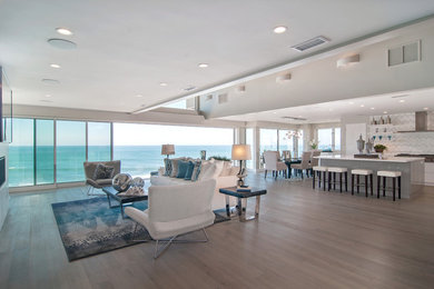 Large trendy l-shaped light wood floor open concept kitchen photo in San Diego with a single-bowl sink, flat-panel cabinets, white cabinets, marble countertops, white backsplash, mosaic tile backsplash, paneled appliances and an island
