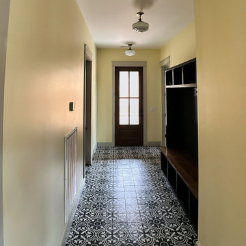 Stylish Entryway Mudroom with Bold Patterned Tile and Custom Storage