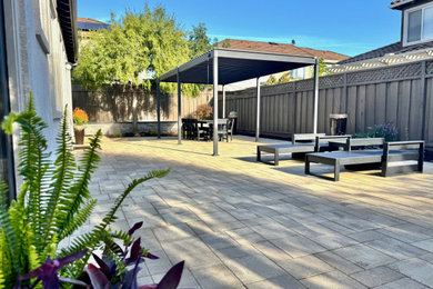 Trendy backyard concrete paver patio photo in San Francisco with a pergola
