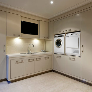 Laundry room - contemporary beige floor laundry room idea in Perth with flat-panel cabinets, beige cabinets, beige walls and a side-by-side washer/dryer