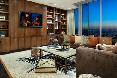Family room - mid-sized southwestern dark wood floor and brown floor family room idea in Dallas with brown walls, no fireplace and a wall-mounted tv