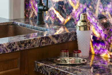 Mid-sized transitional wet bar photo in Philadelphia with an undermount sink, flat-panel cabinets, medium tone wood cabinets, onyx countertops, multicolored backsplash, stone slab backsplash and purple countertops