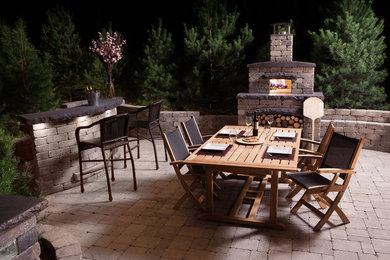Design ideas for a large traditional backyard patio in Other with no cover, concrete pavers and an outdoor kitchen.